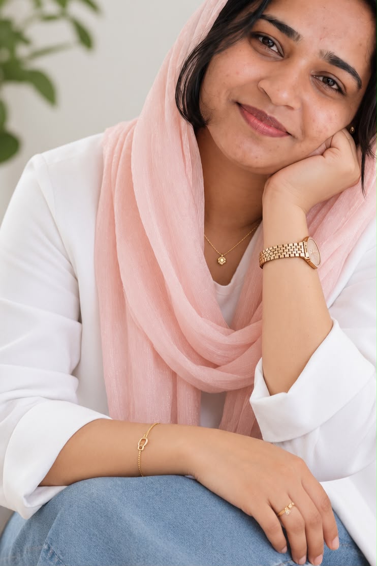 Sahla Umer sitting quietly in a calm, plant-filled counselling space